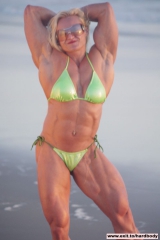 Amazing Muscle Babe posing outdoors