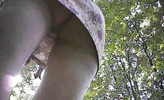 Delicious bimbo walks around the park while her panties are