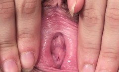 Pigtailed teen spreads pink pussy in closeup
