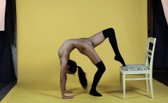 Talented naked gymnast in stockings