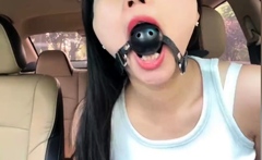 She wears a ball gag in the car